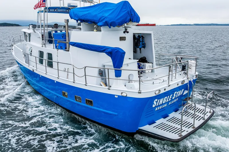 Slide: The Image of Blue 1978 Hidden Harbor Custom Trawler cruising on open water, named "Single Star" from Kodiak, Alaska. - 17