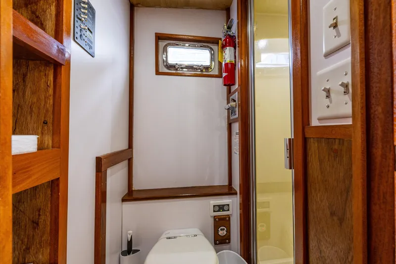Slide: The Image of Bathroom interior of 1978 Hidden Harbor Custom Trawler with wooden accents and compact design. - 22