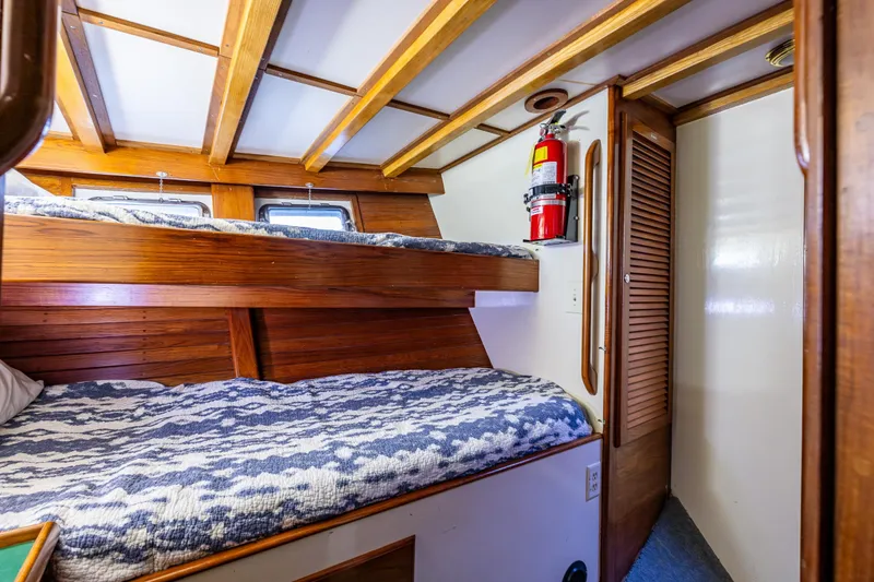 Slide: The Image of Cozy 1978 Hidden Harbor Custom Trawler cabin with wooden bunk beds and nautical decor. - 27