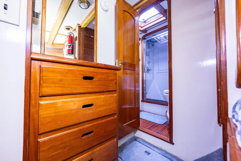 Slide: The Image of Interior of 1978 Hidden Harbor Custom Trawler with wooden cabinetry and bathroom view. - 30