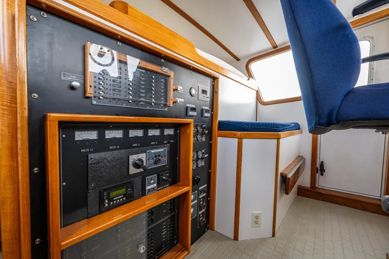 Slide: The Image of Control panel and seating inside a 1978 Hidden Harbor Custom Trawler boat. - 34