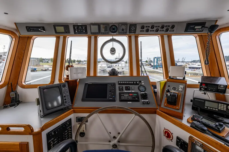 Slide: The Image of 1978 Hidden Harbor Custom Trawler helm with navigation equipment and panoramic windows. - 35