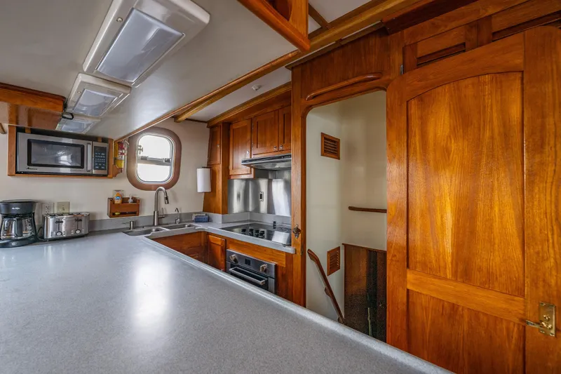 Slide: The Image of 1978 Hidden Harbor Custom Trawler kitchen with wooden cabinetry and modern appliances. - 37