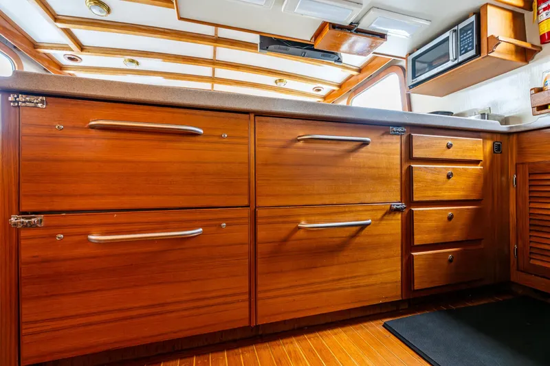 Slide: The Image of 1978 Hidden Harbor Custom Trawler kitchen with wooden cabinets and modern appliances. - 40