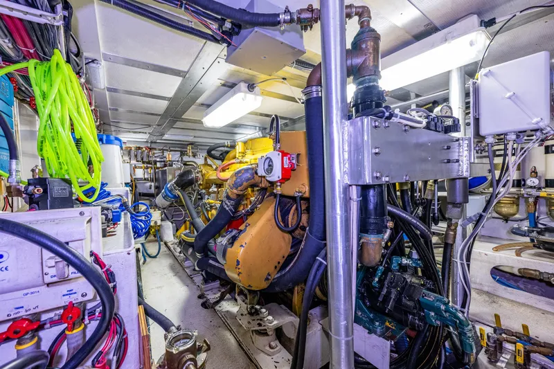 Slide: The Image of Engine room of 1978 Hidden Harbor Custom Trawler with complex machinery and bright lighting. - 44