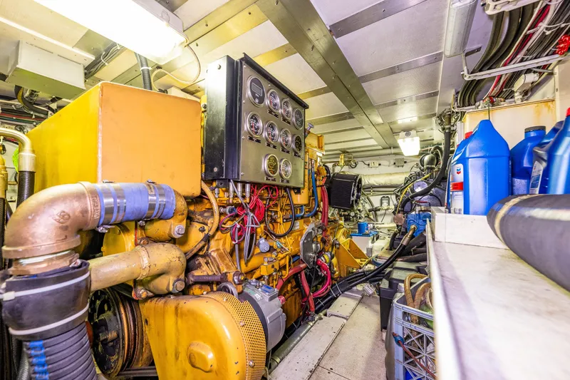 Slide: The Image of Engine room of 1978 Hidden Harbor Custom Trawler with machinery and maintenance supplies. - 46