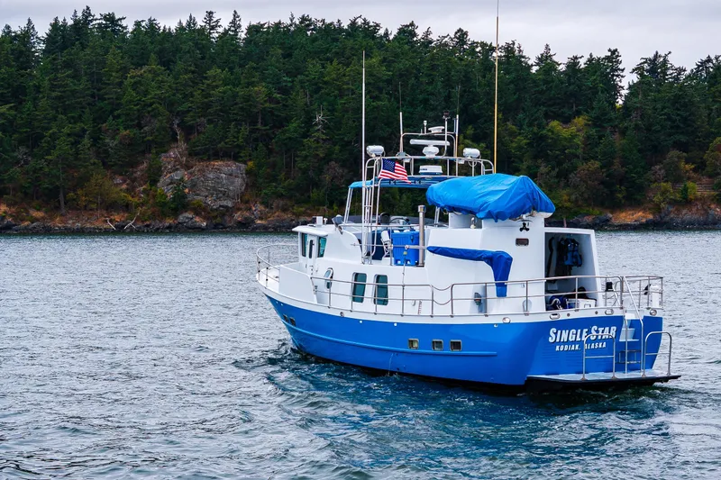 Slide: The Image of 1978 Hidden Harbor Custom Trawler on scenic waterway with forested shoreline. - 5