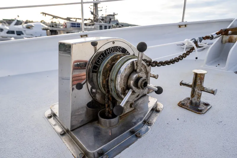 Slide: The Image of Vintage 1978 Hidden Harbor Custom Trawler winch on deck, with nautical equipment in background. - 54