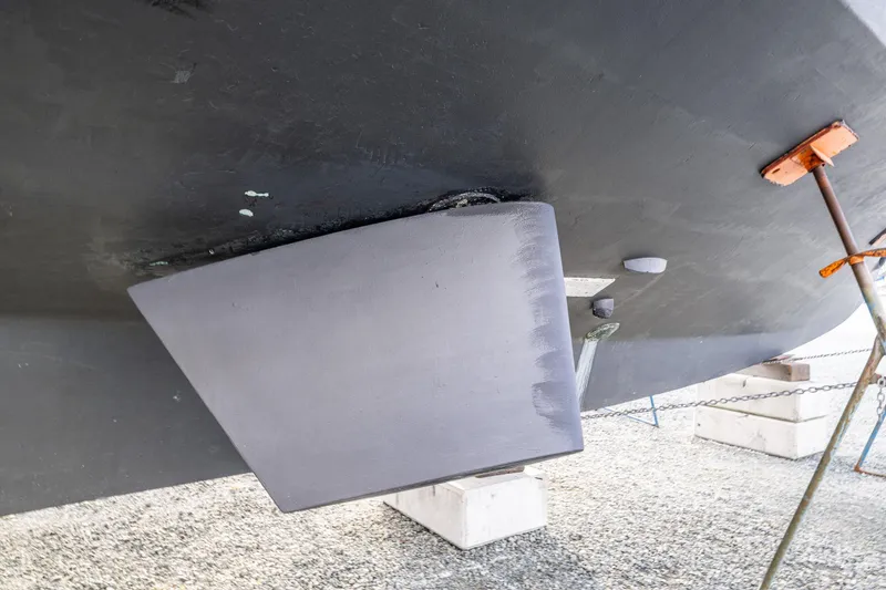 Slide: The Image of 1978 Hidden Harbor Custom Trawler hull detail on dry dock, showcasing rudder and support structures. - 57