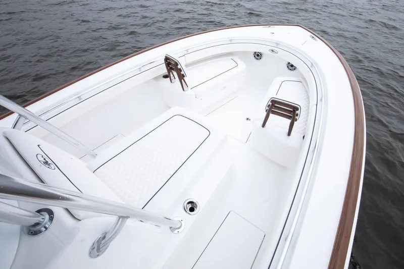 Slide: The Image of 2026 Valhalla Boatworks V-29 Hybrid, sleek white deck, elegant seating, on calm water. - 10