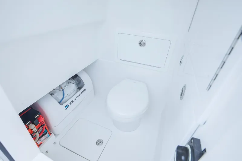 Slide: The Image of Interior of 2026 Valhalla V-29 Hybrid boat featuring a compact marine toilet. - 14