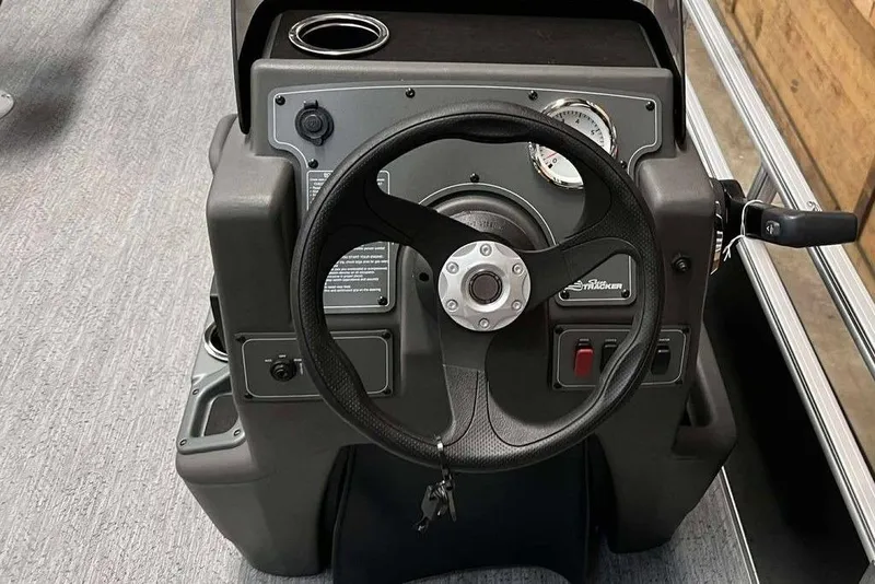 Slide: The Image of 2026 Sun Tracker Bass Buggy® 16 XL Select steering console with controls and gauges. - 4