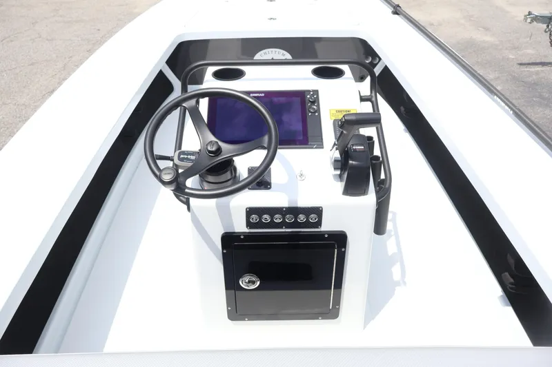 Slide: The Image of 2026 Chittum Skiffs Islamorada 21 boat console with steering wheel and navigation system. - 12