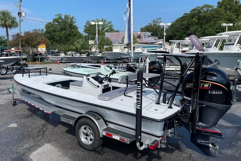 Slide: The Image of 2026 Chittum Skiffs Islamorada 21 boat on trailer, displayed outdoors at dealership. - 2