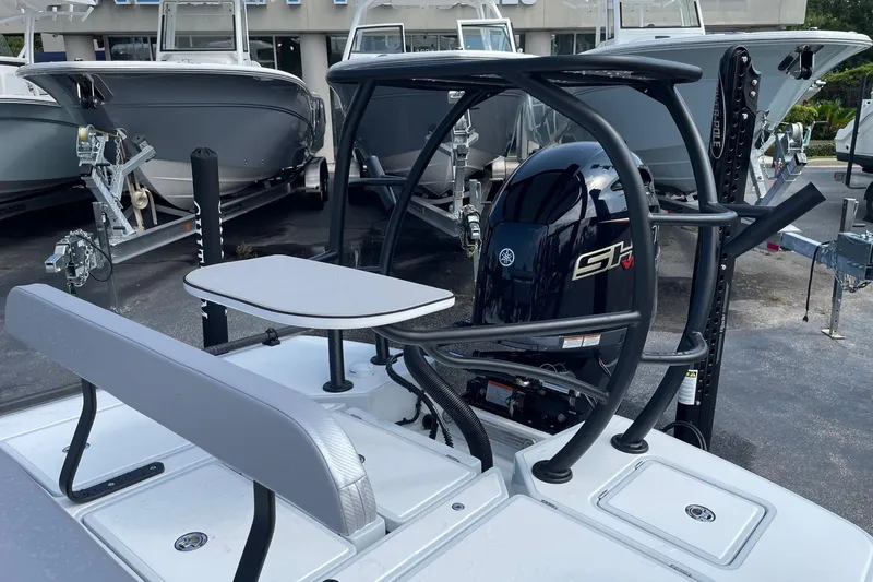 Slide: The Image of 2026 Chittum Skiffs Islamorada 21 with Yamaha outboard motor, displayed at a dealership. - 21