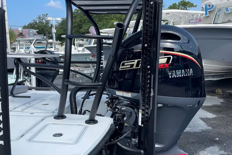 Slide: The Image of 2026 Chittum Skiffs Islamorada 21 boat with Yamaha engine, docked outdoors. - 22