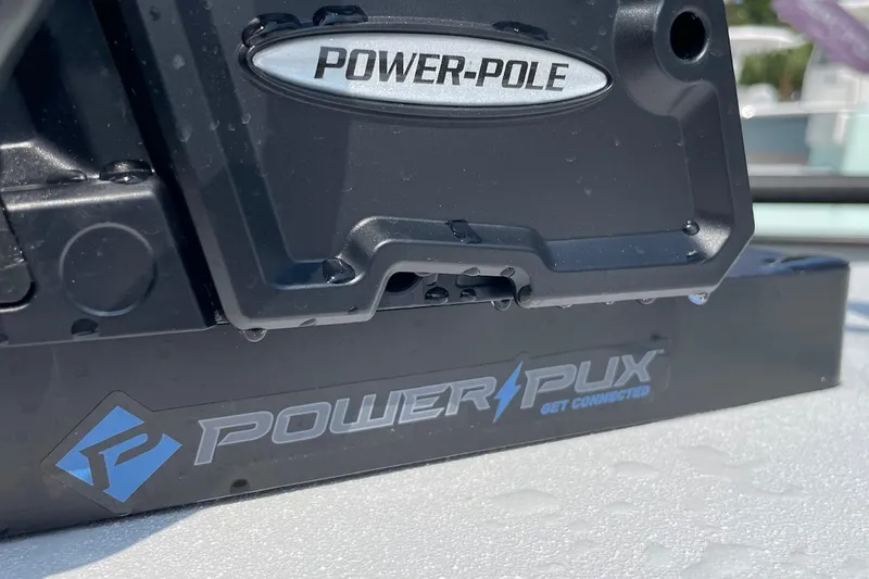 Slide: The Image of Close-up of a 2026 Chittum Skiffs Islamorada 21 boat motor with coiled cable. - 32