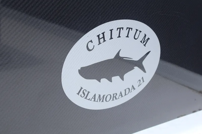 Slide: The Image of 2026 Chittum Skiffs Islamorada 21 with Yamaha 150 engine, parked on trailer. - 7