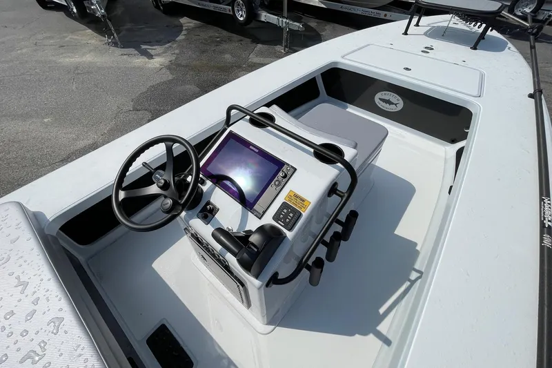 Slide: The Image of Chittum Skiffs Islamorada 21 logo on carbon fiber surface, 2026 model. - 8