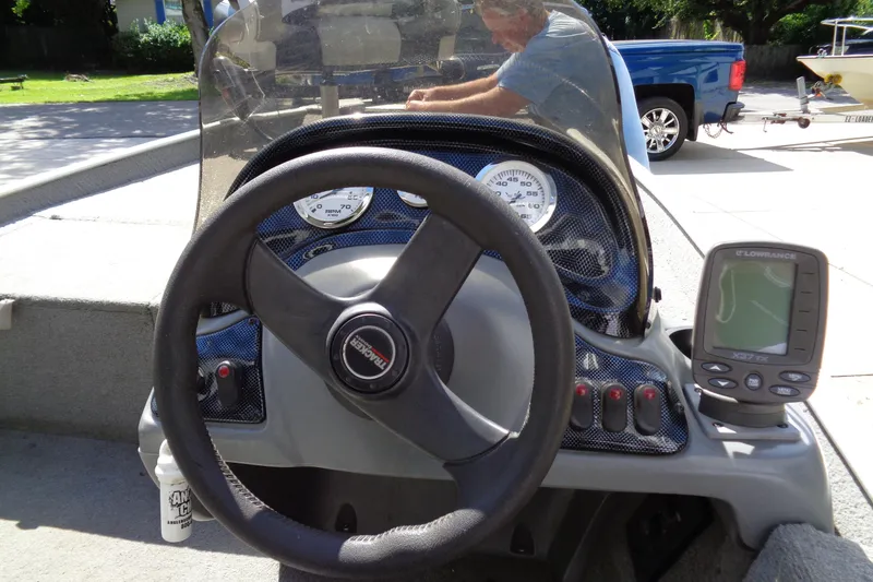 Slide: The Image of 2006 Bass Tracker PT175 boat dashboard with steering wheel and fish finder. - 10