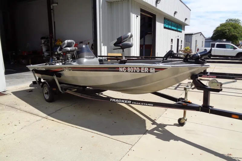 Slide: The Image of 2006 Bass Tracker PT175 boat on trailer outside a garage. - 4