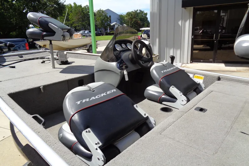 Slide: The Image of 2006 Bass Tracker PT175 boat interior with steering wheel and Tracker seats. - 6