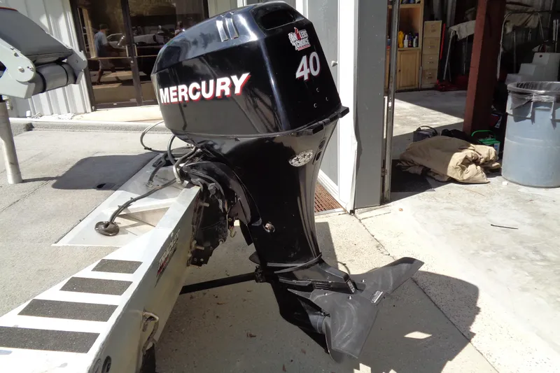 Slide: The Image of 2006 Bass Tracker PT175 with Mercury 40 outboard motor in a garage setting. - 7