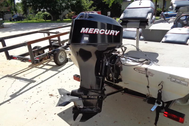 Slide: The Image of 2006 Bass Tracker PT175 boat with Mercury outboard motor, parked on a trailer. - 8