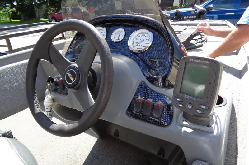 Slide: The Image of 2006 Bass Tracker PT175 boat dashboard with steering wheel and Lowrance fish finder. - 9