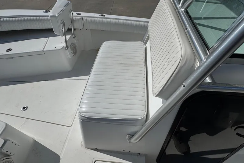 Slide: The Image of 2000 Regulator 26 Center Console boat interior with white seating and console. - 12