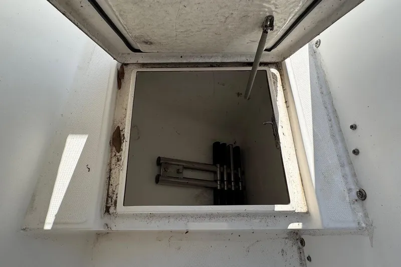 Slide: The Image of Open storage compartment on 2000 Regulator 26 Center Console boat. - 13