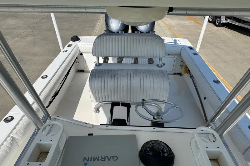 Slide: The Image of 2000 Regulator 26 Center Console boat interior with seating and steering wheel. - 14