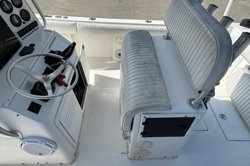 Slide: The Image of 2000 Regulator 26 Center Console boat interior with steering wheel and seating. - 15