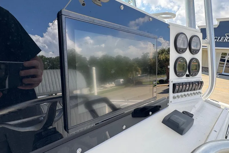 Slide: The Image of Control panel of a 2000 Regulator 26 Center Console boat with gauges and Garmin display. - 17