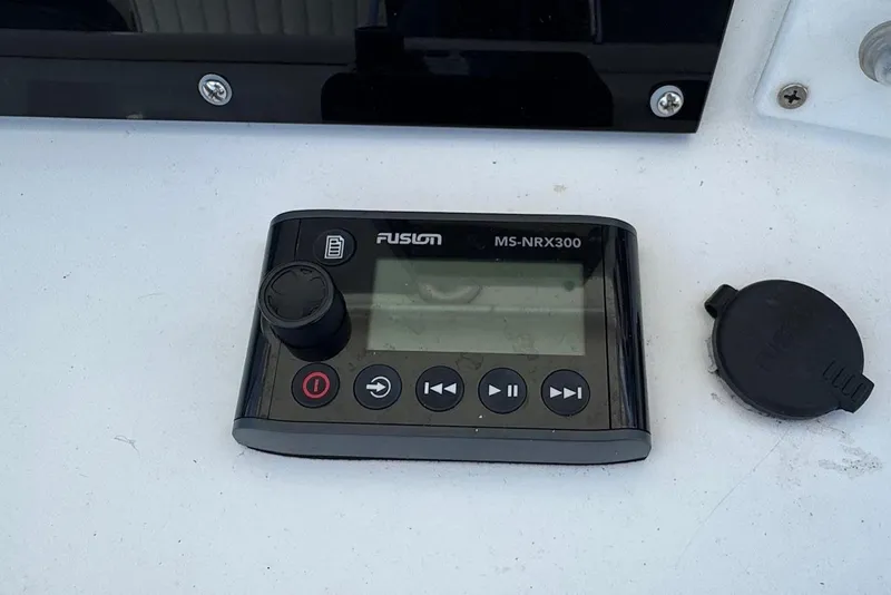 Slide: The Image of Fusion MS-NRX300 marine stereo controller on a Regulator 26 Center Console, 2000 model. - 19