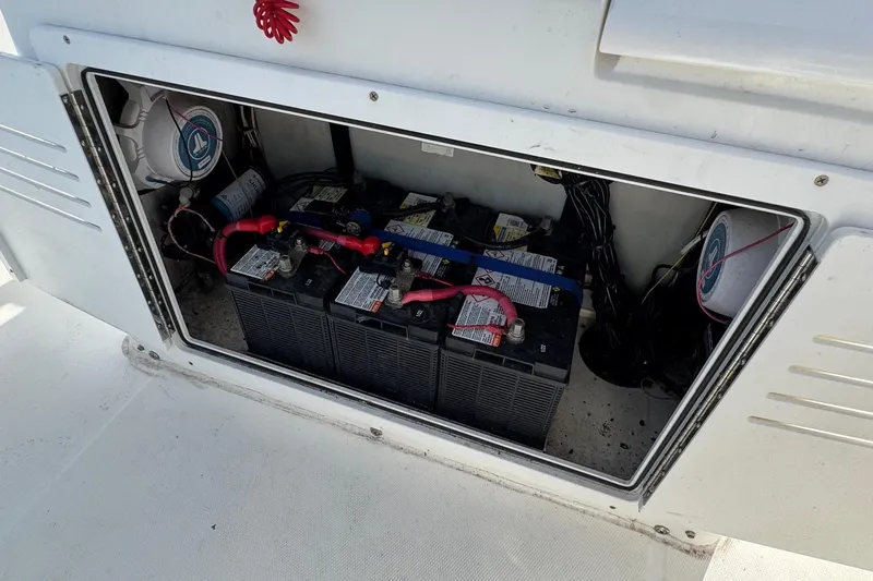 Slide: The Image of Battery compartment of a 2000 Regulator 26 Center Console boat, showing multiple batteries. - 20