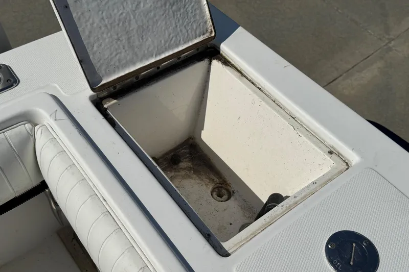Slide: The Image of Open storage compartment on a 2000 Regulator 26 Center Console boat. - 24