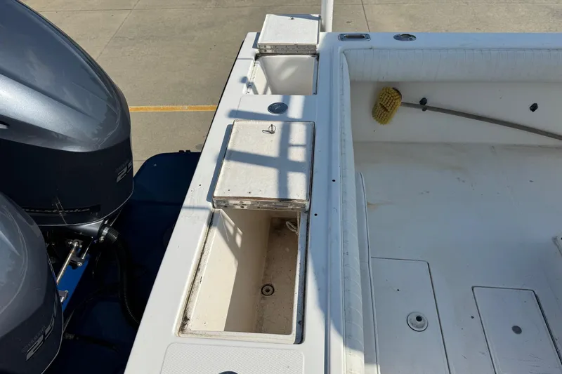 Slide: The Image of 2000 Regulator 26 Center Console boat deck with storage compartments and dual engines. - 25