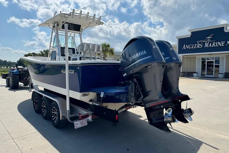 Slide: The Image of 2000 Regulator 26 Center Console boat with twin Yamaha engines at Anglers Marine. - 4