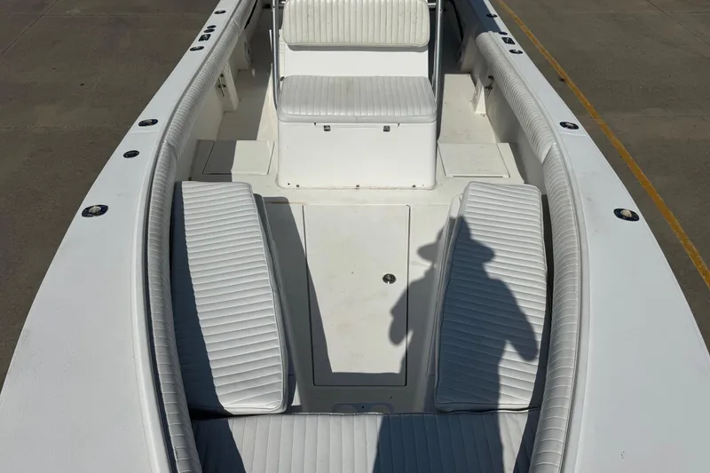 Slide: The Image of 2000 Regulator 26 Center Console boat interior with white seating and shadow. - 7