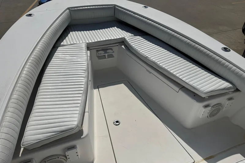 Slide: The Image of 2000 Regulator 26 Center Console boat with cushioned seating and spacious deck. - 8