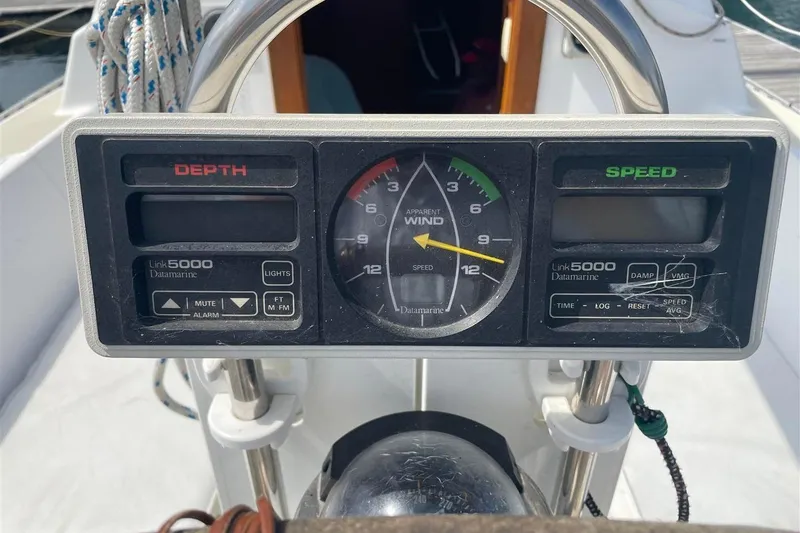 Slide: The Image of 1986 J Boats J/28 cockpit instruments showing depth, wind, and speed gauges. - 10