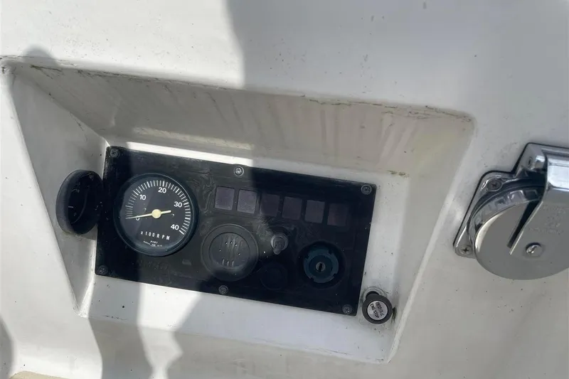 Slide: The Image of Control panel of a 1986 J Boats J/28 sailboat, featuring RPM gauge and switches. - 11