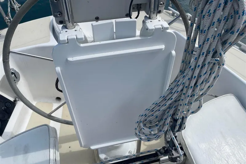 Slide: The Image of Cockpit of 1986 J Boats J/28 sailboat with steering wheel and coiled ropes. - 16