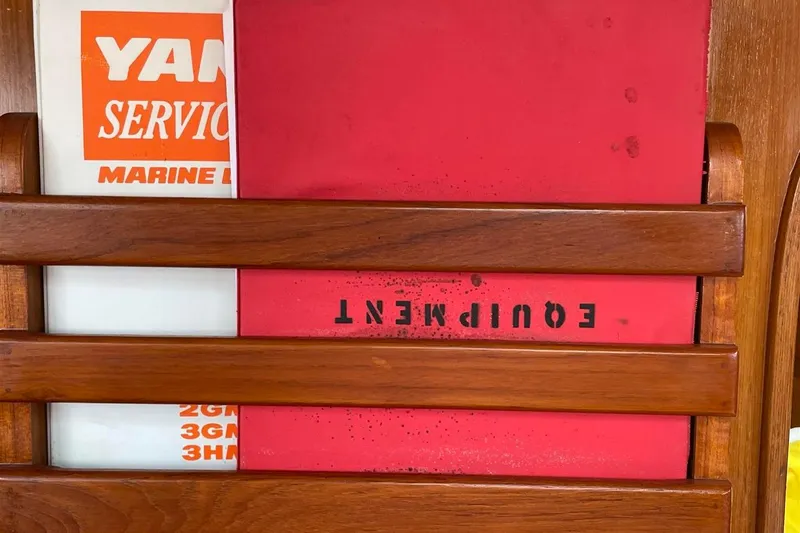 Slide: The Image of Wooden rack holding manuals on a 1986 J Boats J/28 sailboat. - 25