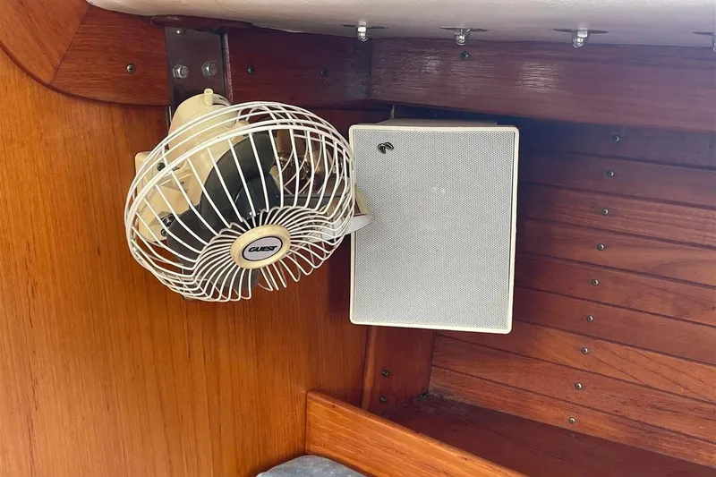 Slide: The Image of 1986 J Boats J/28 interior with fan and speaker on wooden paneling. - 27