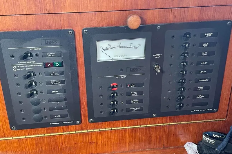 Slide: The Image of Electrical control panel on a 1986 J Boats J/28 sailboat, featuring AC and DC power switches. - 28