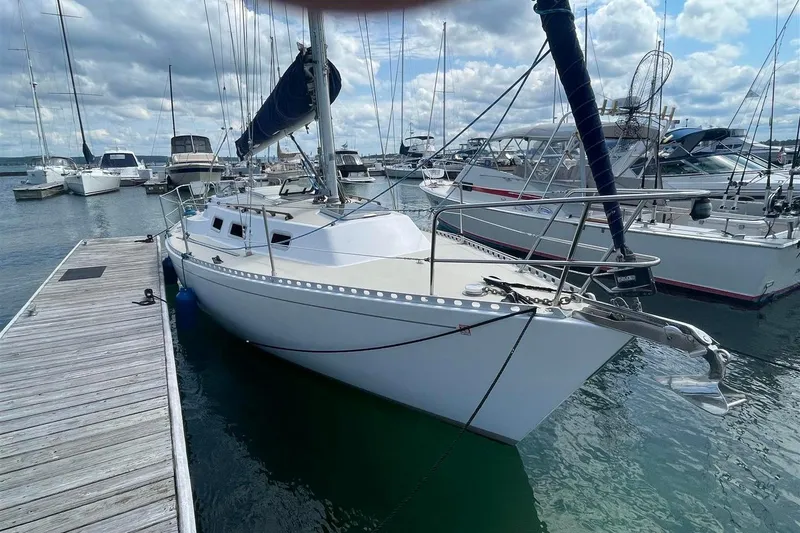 Slide: The Image of 1986 J Boats J/28 sailboat docked at marina under cloudy sky. - 3