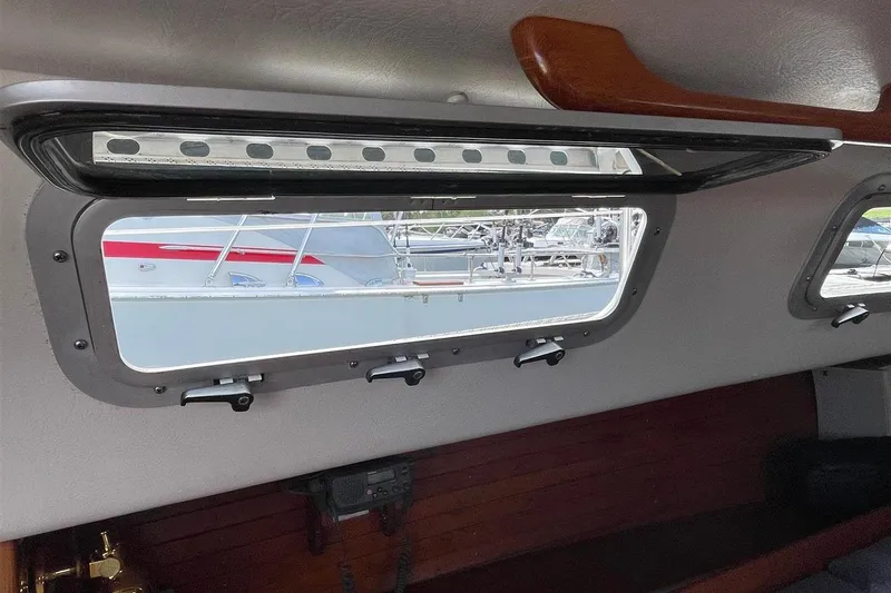 Slide: The Image of Interior view of a 1986 J Boats J/28 sailboat, showcasing a cabin window. - 38