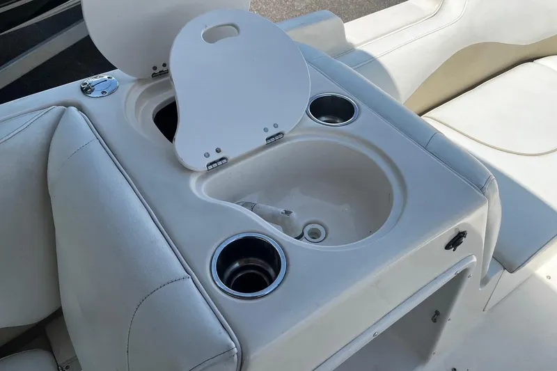 Slide: The Image of 2008 Hurricane FD202 boat interior with cup holders and storage compartment. - 10